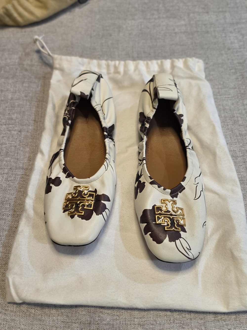Tory Burch White Floral Logo Ballet Flats with Gold Emblem